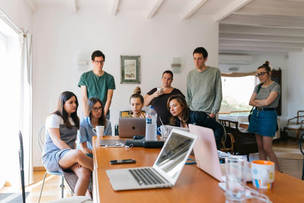 A group of developers architecting cloud solutions around laptops